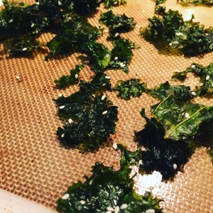 Quick and easy kale chips, baked with sesame seeds.